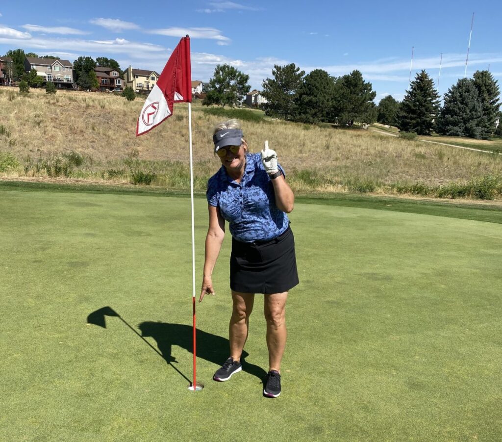 Theresa Leider celebrating a hole-in-one at The Links Golf Course in Highlands Ranch, Colorado.