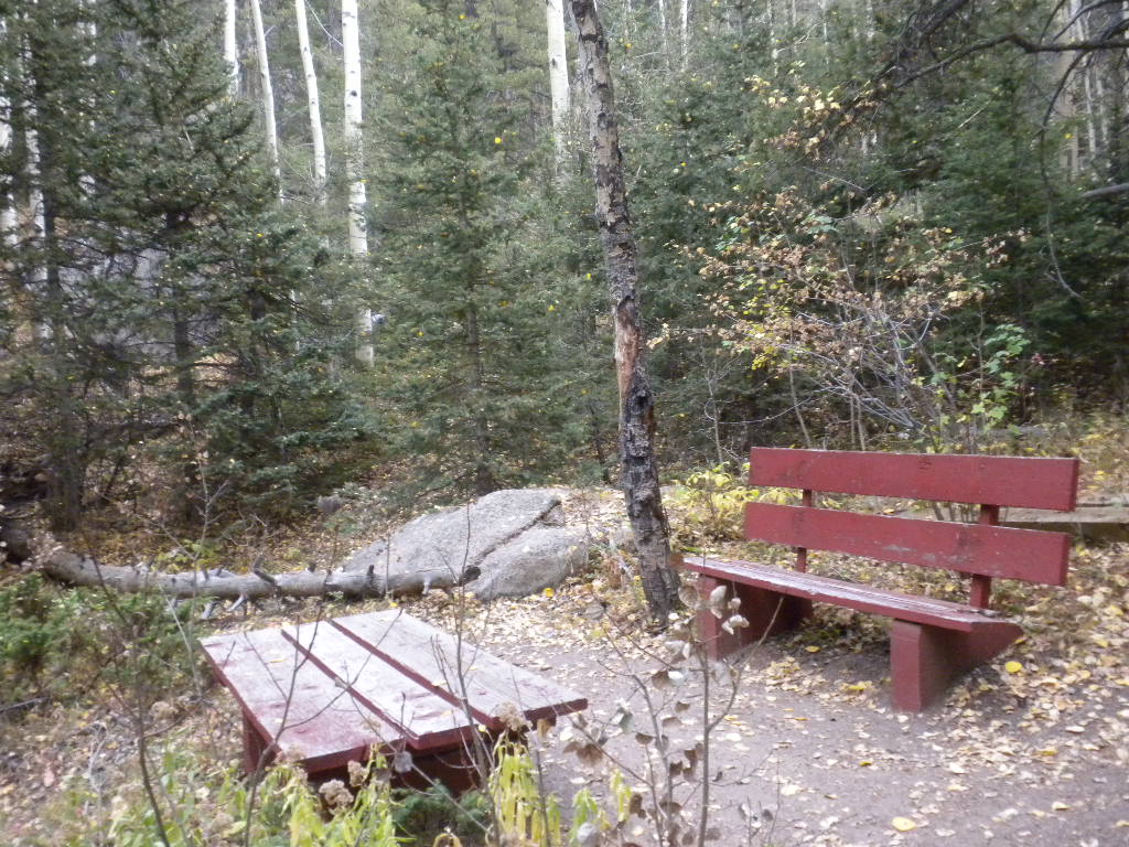 Red bench along the Indian Creek trail near Sedalia, Colorado.